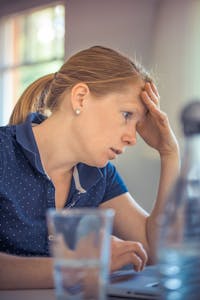 Businesswoman showing stress and concentration while working at her desk.